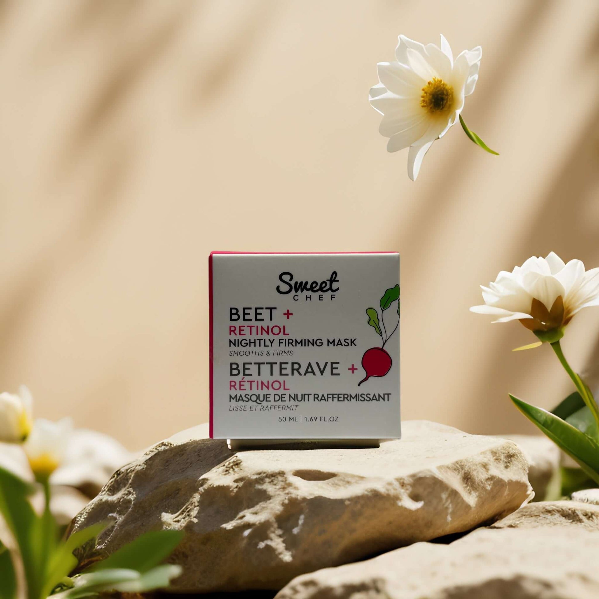 Sweet Chef Beet + Retinol Night Mask on a stone surface surrounded by flowers, 1.7 oz firming cream.