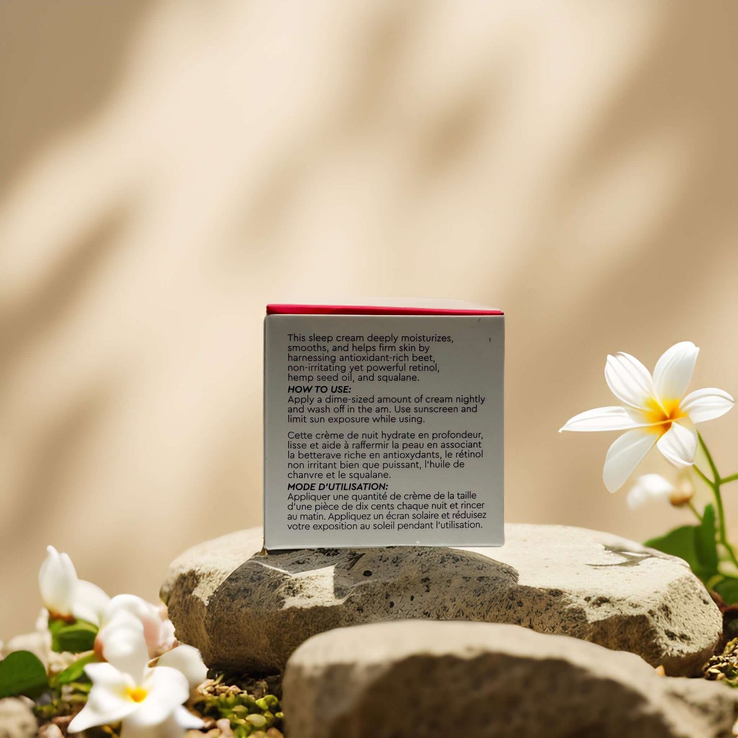 Beet and retinol overnight mask by Sweet Chef on a stone surface, surrounded by flowers and greenery.