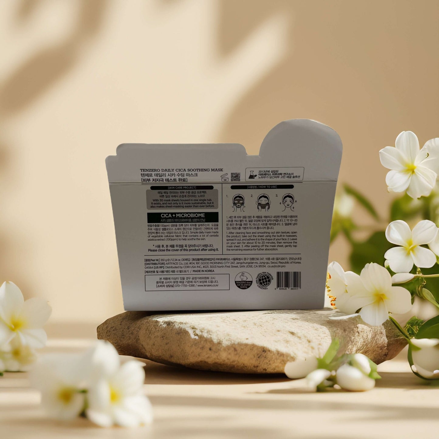 Back of Tenzero Daily CICA Soothing Facial Mask packaging, showcasing ingredients and benefits with floral accents.