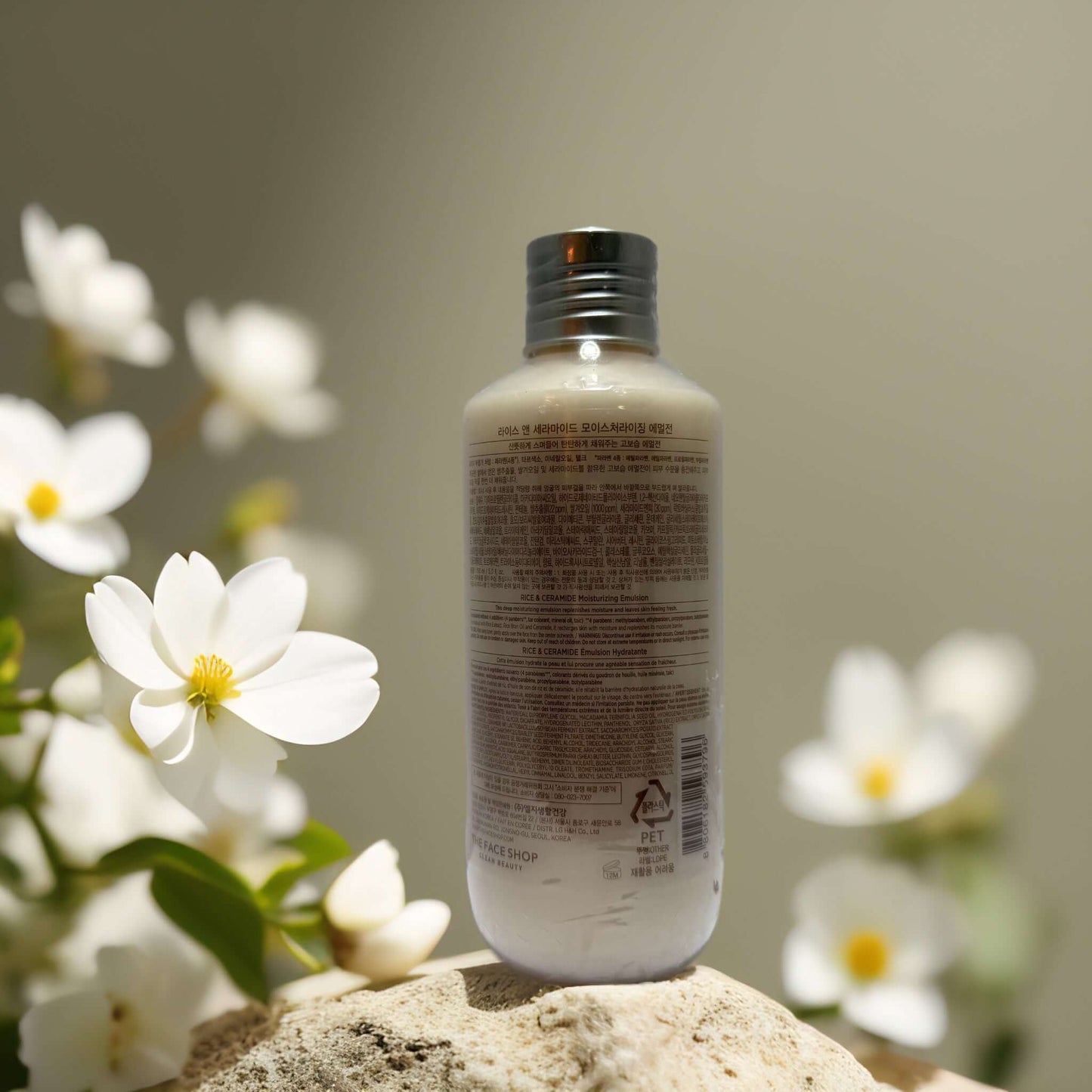 Lightweight Hydration Rice Ceramide Emulsion bottle with flowers, offering buildable hydration and skin barrier support.