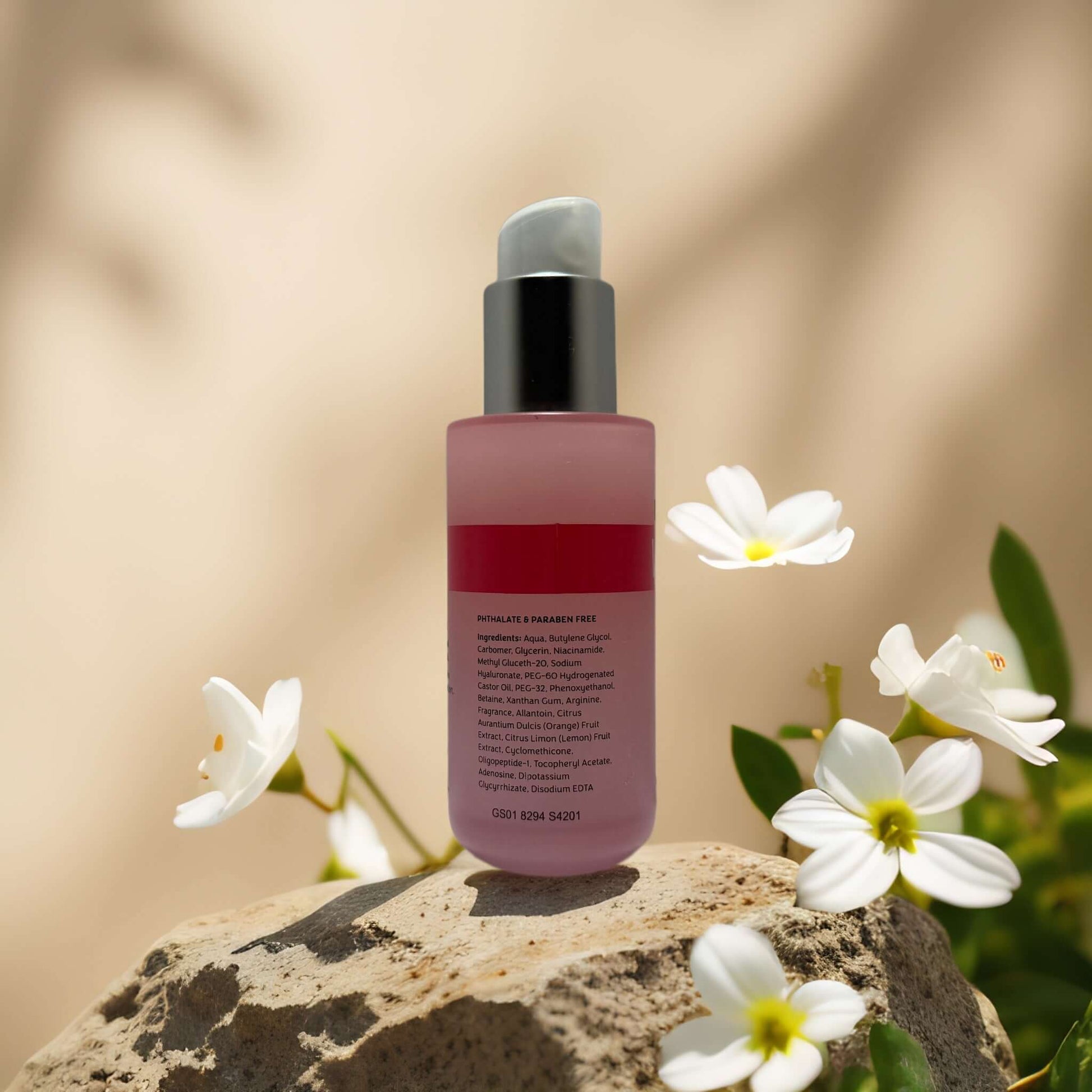 Brightening Vitamin C face serum by Precision Beauty on a rock with flowers, promoting a luminous glow and even skin tone.