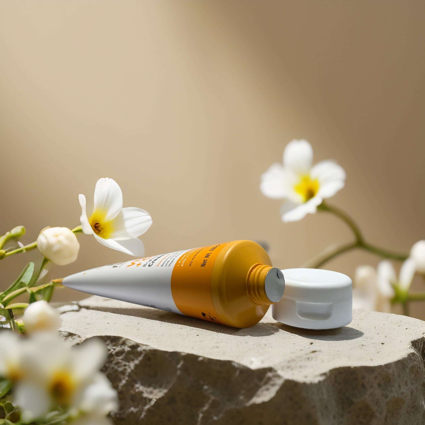 Vitamin C + Collagen Cleanser by By Nature on a stone, surrounded by white flowers, promoting hydration and radiance.