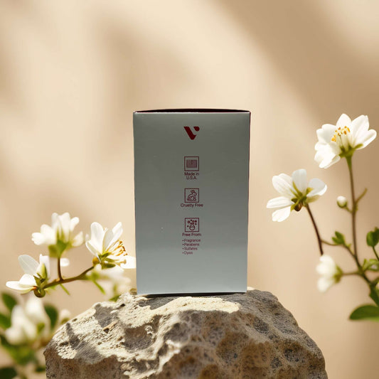 Rejuvenate & Firm Retinol Night Cream packaging surrounded by flowers, showcasing cruelty-free and natural ingredients.