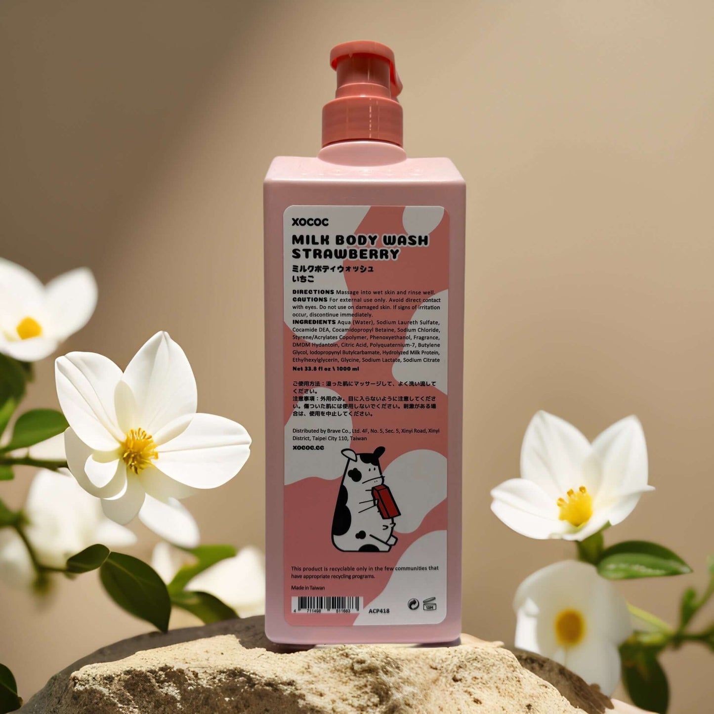 XOCOC Milk Body Wash Strawberry bottle with cow design, surrounded by flowers, showcasing playful packaging.