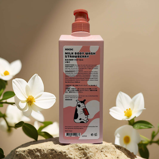 XOCOC Milk Body Wash Strawberry bottle with cow design, surrounded by flowers, showcasing playful packaging.