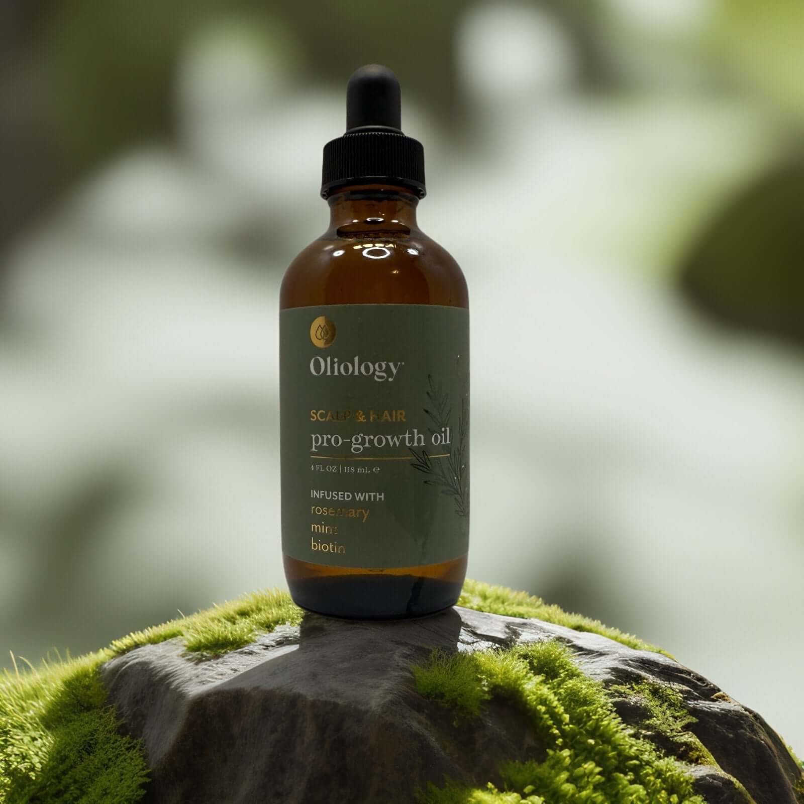 Oliology Pro-Growth Hair & Scalp Oil bottle on moss