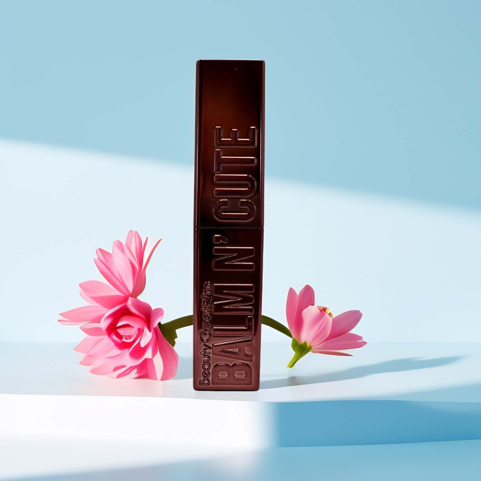 Beauty Creations Balm N’ Cute tinted lip balm against pastel background.