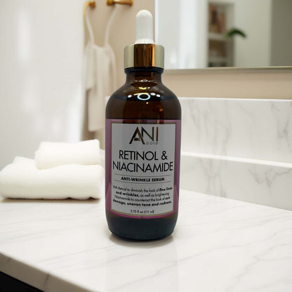 ANI Gold Retinol & Niacinamide Anti-Wrinkle Serum 3.75oz bottle on marble counter.