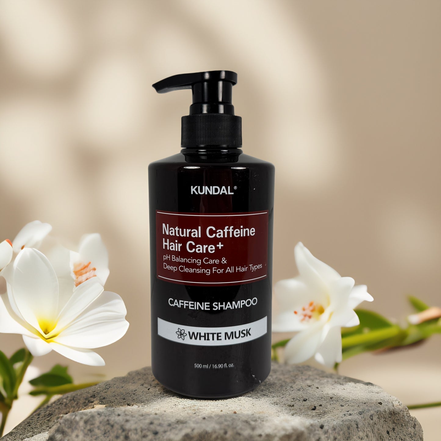 Deep Cleansing & pH Balancing | Caffeine Shampoo by KUNDAL – 16.9 fl oz in a stylish black bottle with floral background.