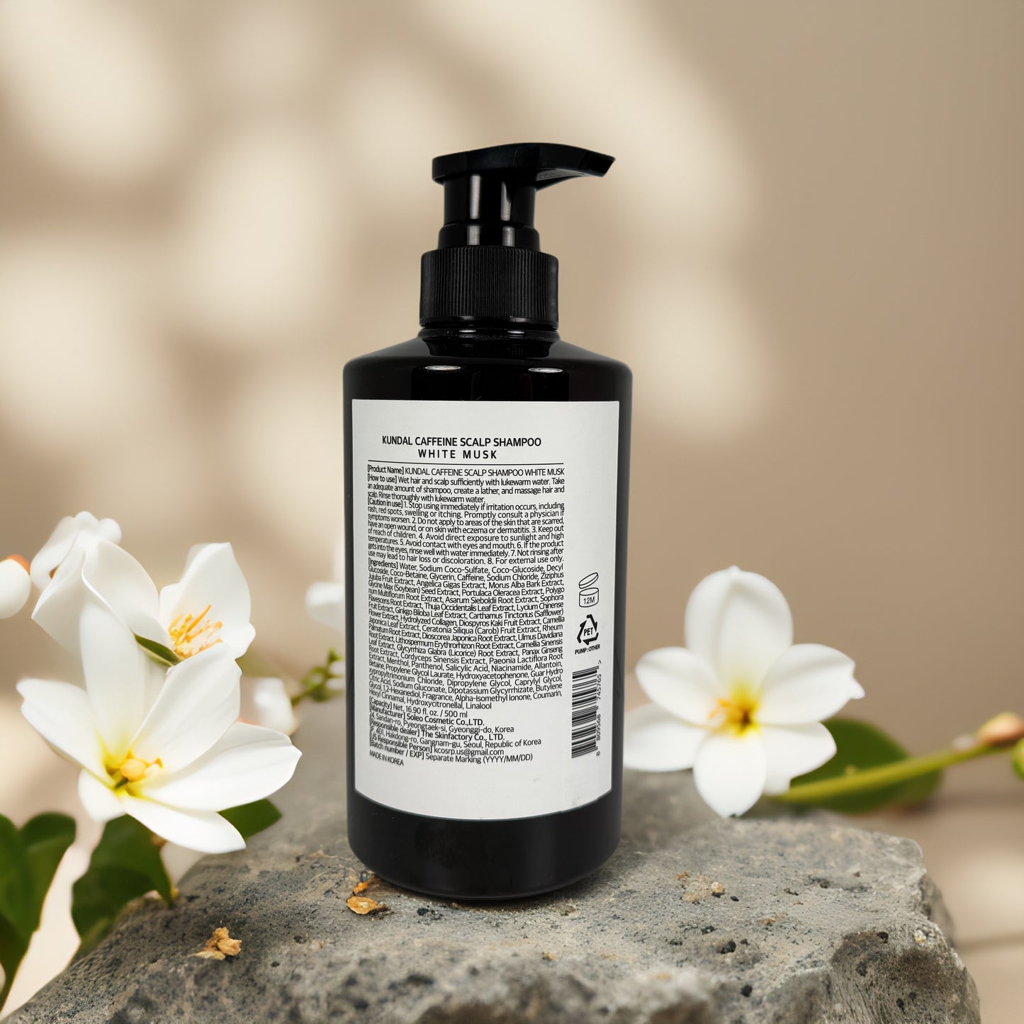 Deep Cleansing & pH Balancing | Caffeine Shampoo by KUNDAL – 16.9 fl oz bottle with floral background.