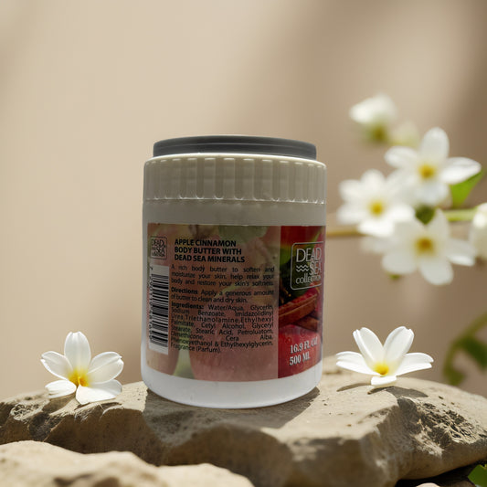 Apple Cinnamon Body Butter from Dead Sea Collection in an elegant jar with floral backdrop.