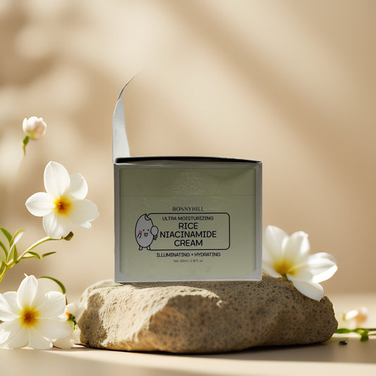 Bonnyhill Rice Niacinamide Cream on stone with flowers, illuminating and hydrating face cream for bright skin.