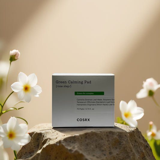 COSRX Green Calming Pad packaging on a stone with flowers, soothing toner pads for sensitive skin, 70 pads, 4.73 fl oz.