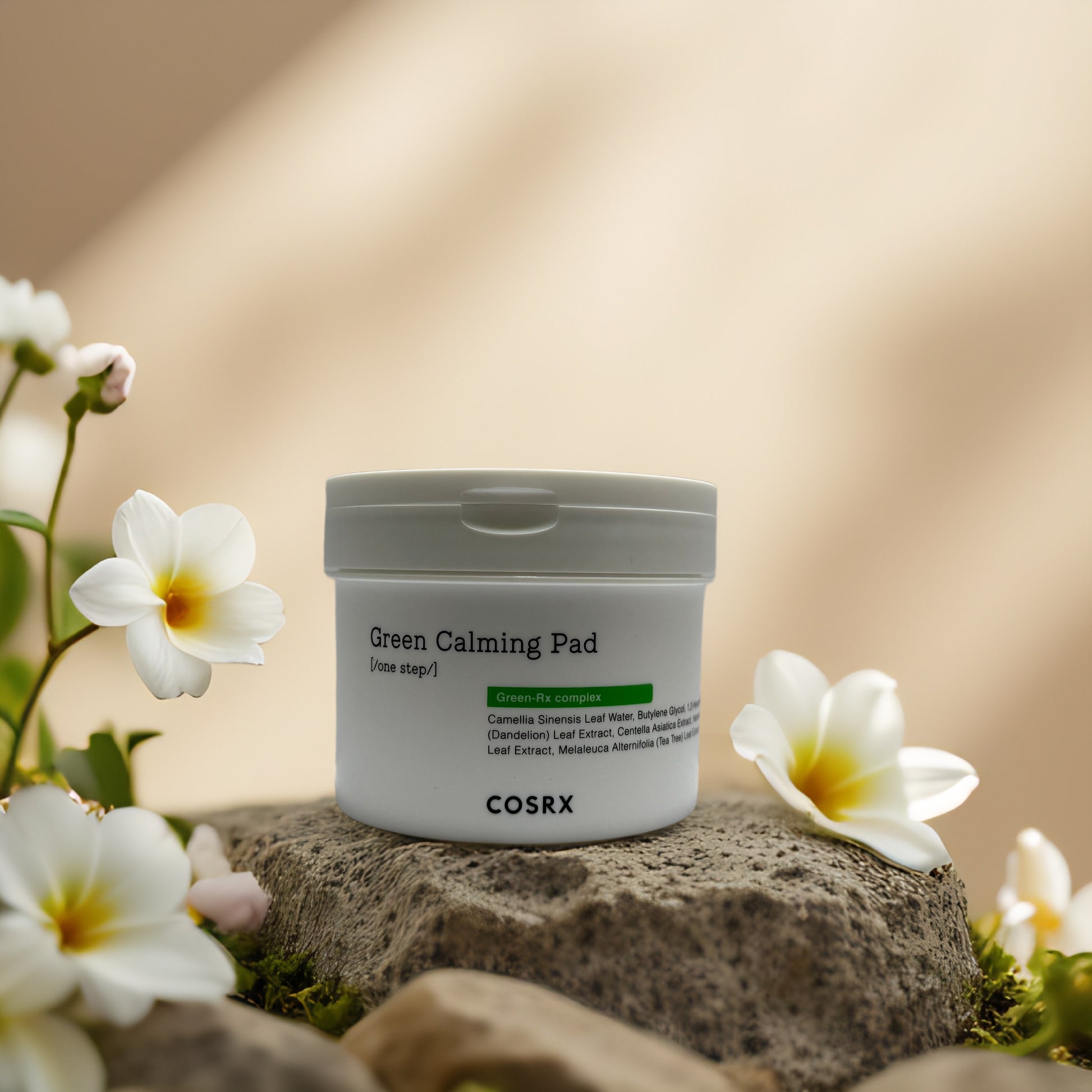 COSRX Green Calming Pad in a soothing setting with flowers, ideal for calming sensitive skin.