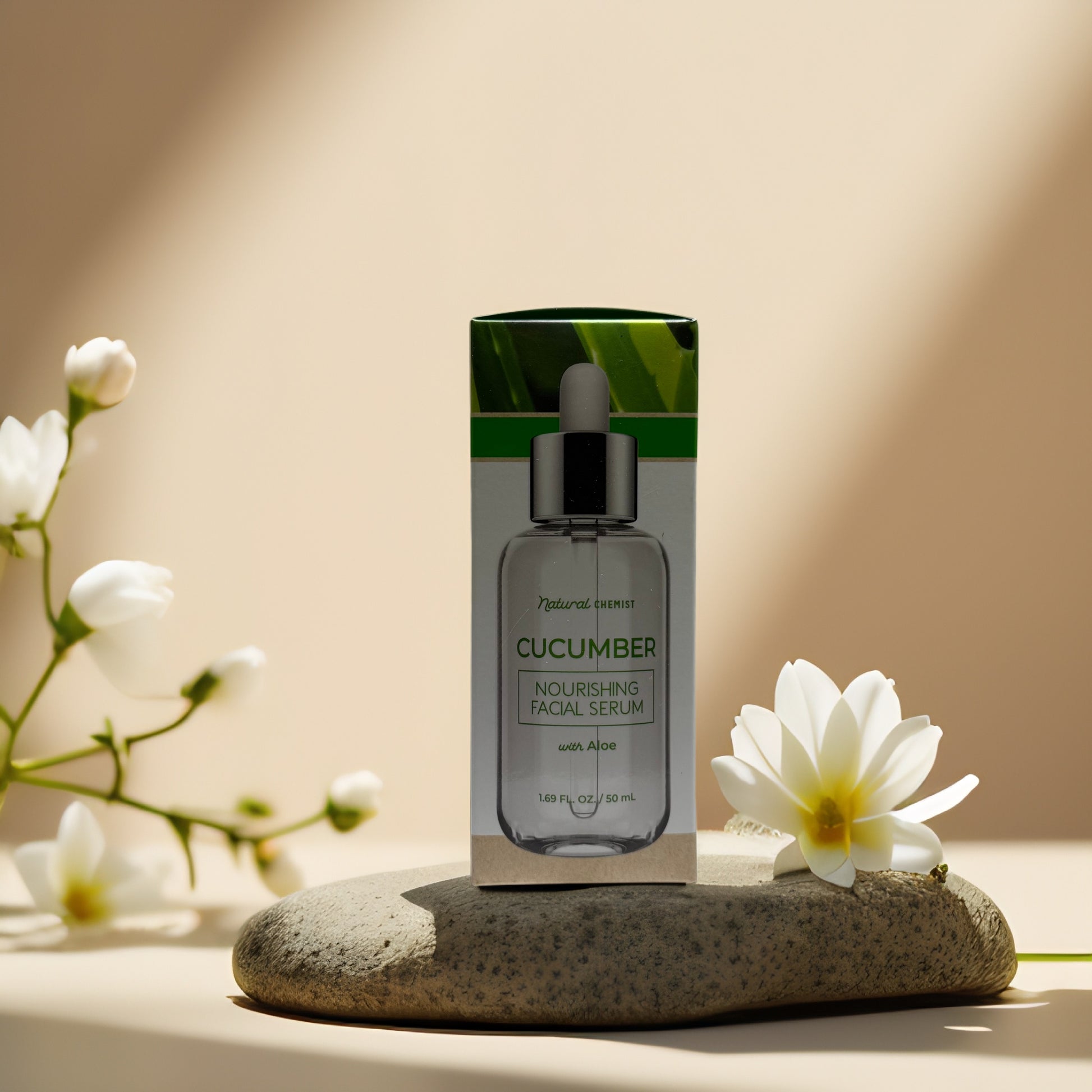 Cucumber Aloe Nourishing Facial Serum by Natural Chemist on a stone with flowers, 1.69 fl oz.