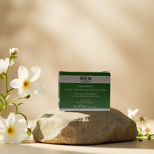 REN Evercalm Rescue Mask packaging on a stone with flowers, designed for sensitive skin to soothe and hydrate.
