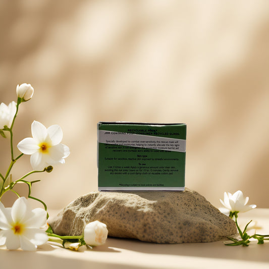 REN Clean Skincare Evercalm Rescue Mask packaging with flowers on a stone background.
