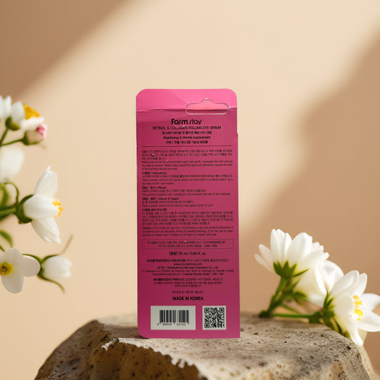 Back view of Farm Stay Retinol Collagen Eye Serum packaging, showcasing product details on a stone surface.