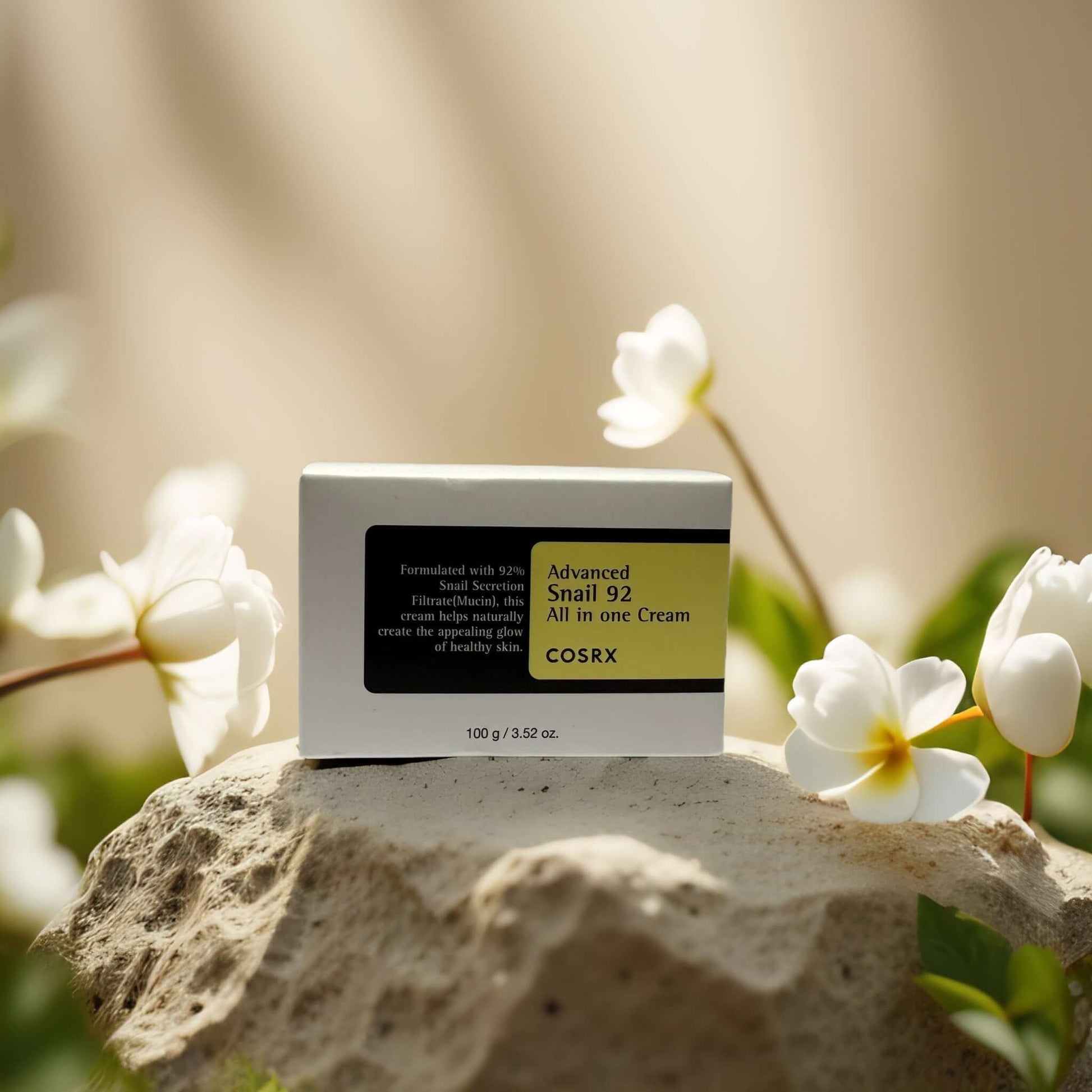 COSRX Advanced Snail 92 Facial Cream in a serene floral setting, showcasing its hydrating benefits for sensitive skin.