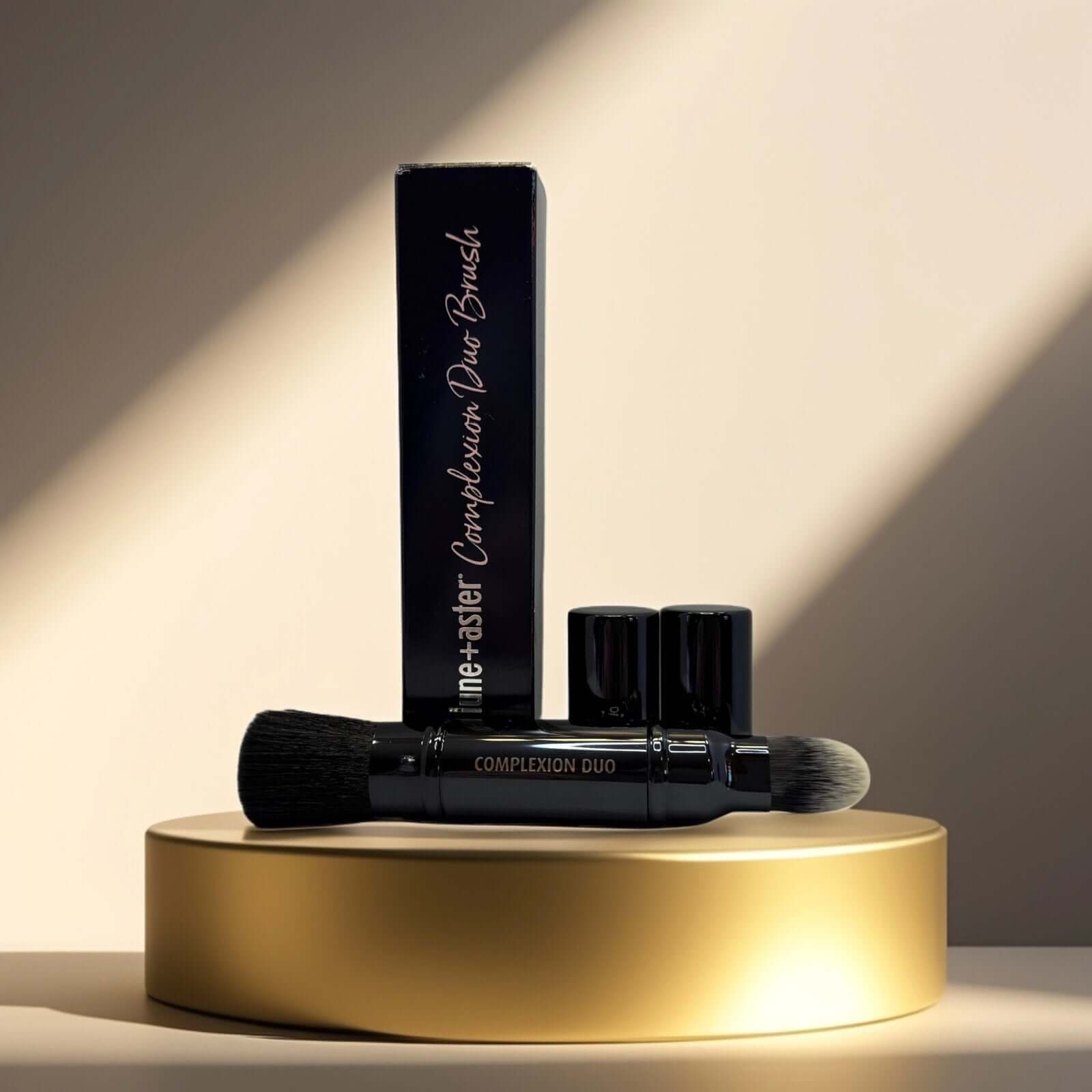 Lune+Aster Complexion Duo Brush with sleek packaging on display.