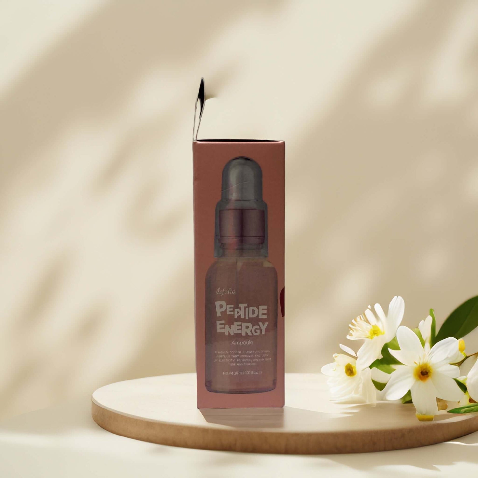 Esfolio Peptide Energy Ampoule in elegant packaging with flowers