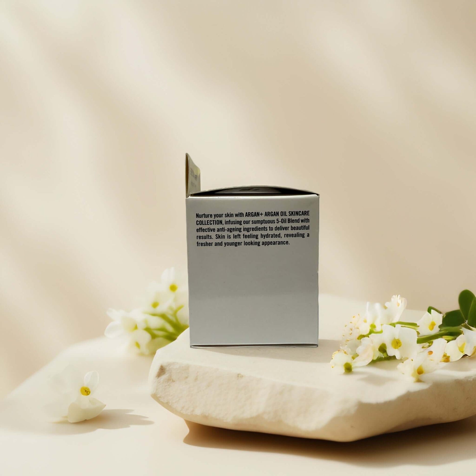 Hydrating day cream packaging with floral accents.
