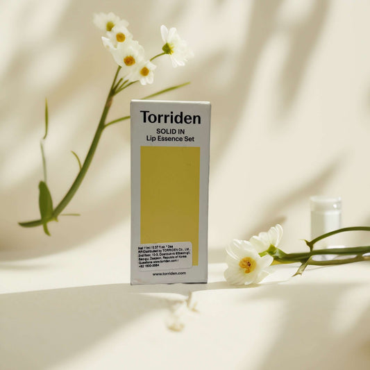 Torriden Solid In Lip Essence Set packaging with white flowers.
