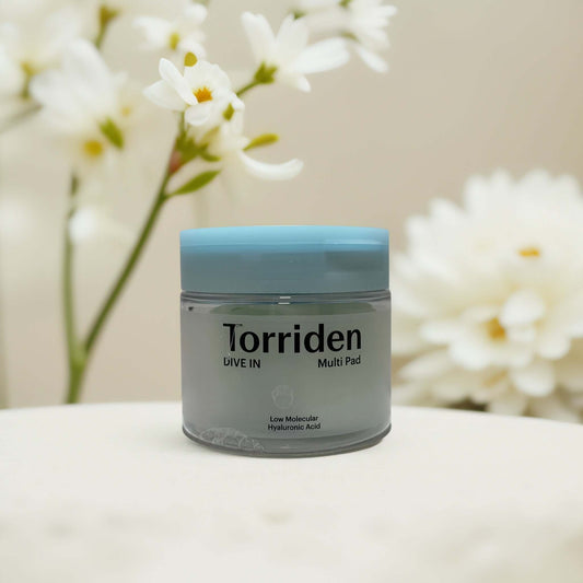Torriden Dive-In Multi Pad jar with flowers in background.
