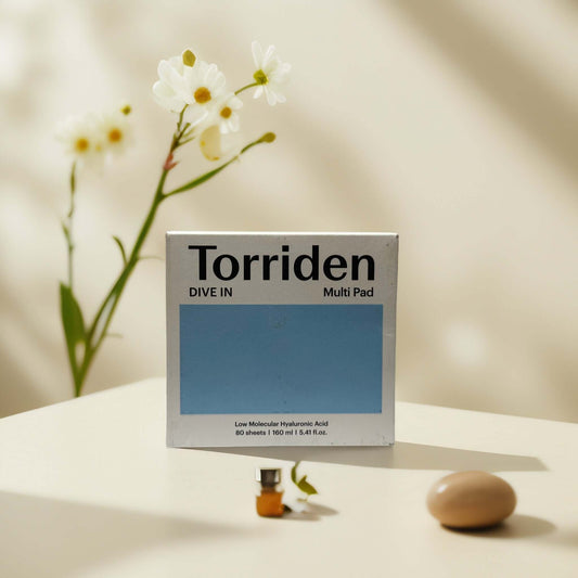 Torriden Dive-In Multi Pad packaging with flowers and skincare.