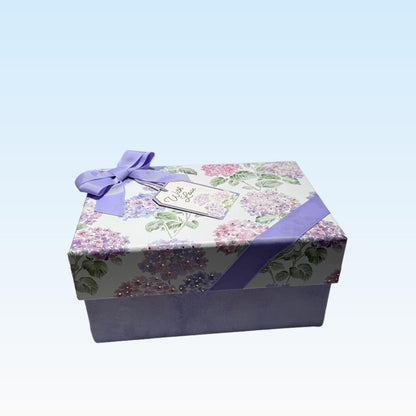 One of a Kind Curated Gift Box with a Handmade Skincare Product by Queen City Skincare elegantly wrapped in floral design.