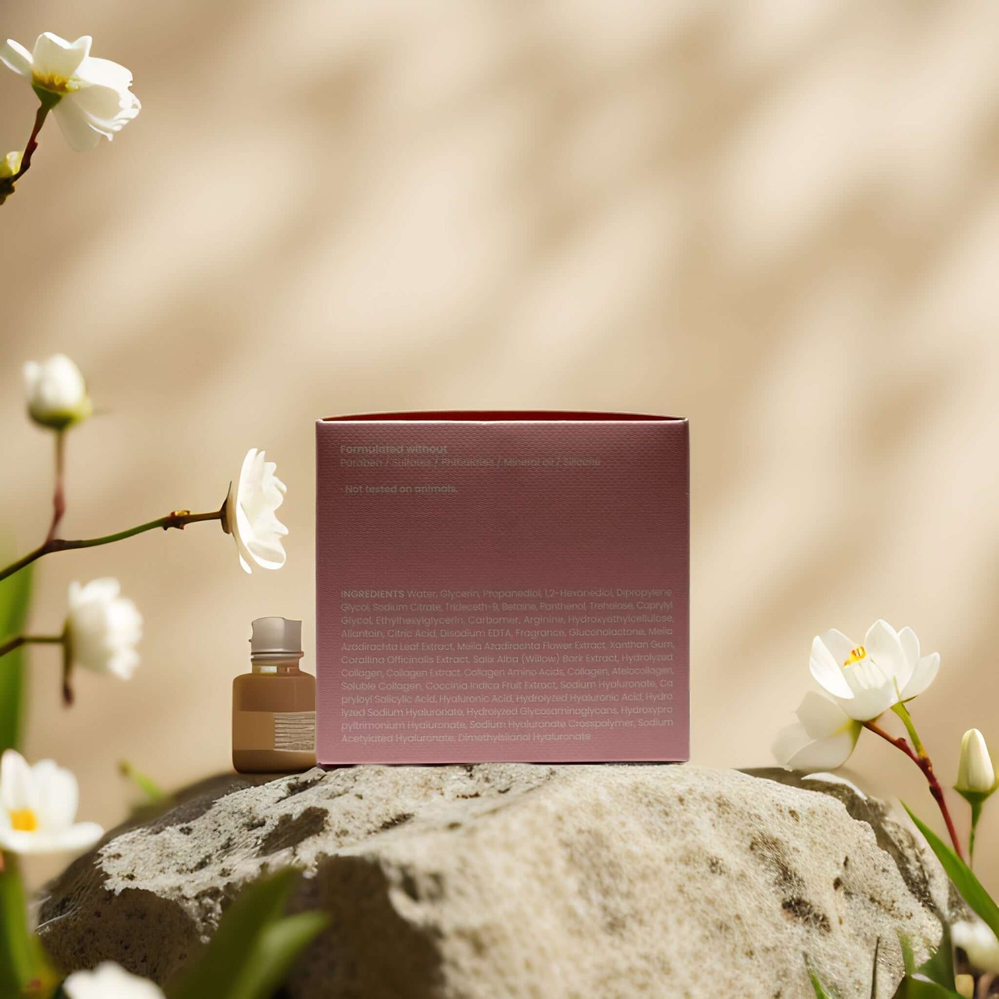 Collagen essence pads by Maske Lab on a stone surrounded by flowers, showcasing elegant packaging and product.
