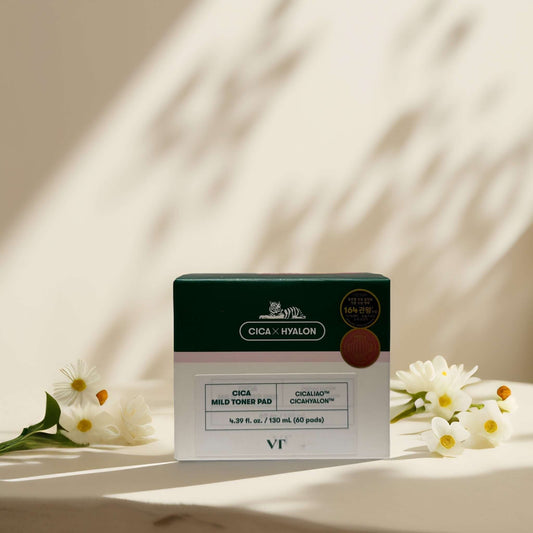 VT Cica Mild Toner Pad box with floral accents on a surface.