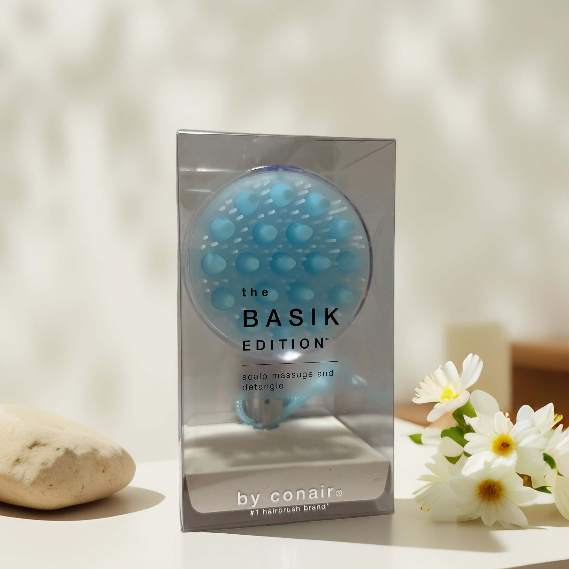 Soothing scalp massage brush in packaging by Conair.
