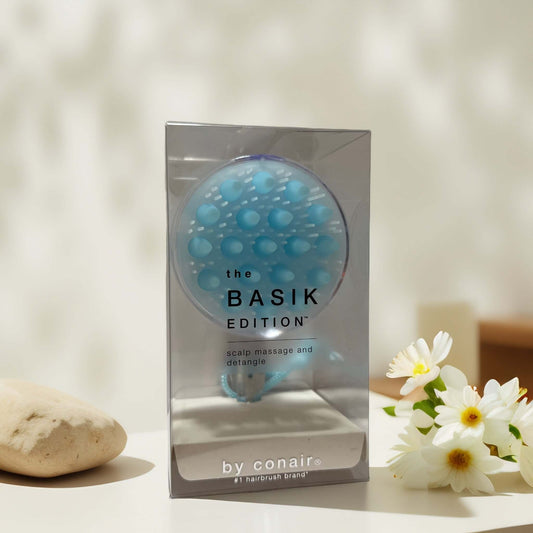 Soothing scalp massage brush in packaging by Conair.