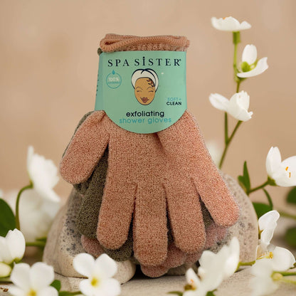 Spa exfoliating shower gloves in assorted colors with packaging, ideal for full-body exfoliation and cleansing.