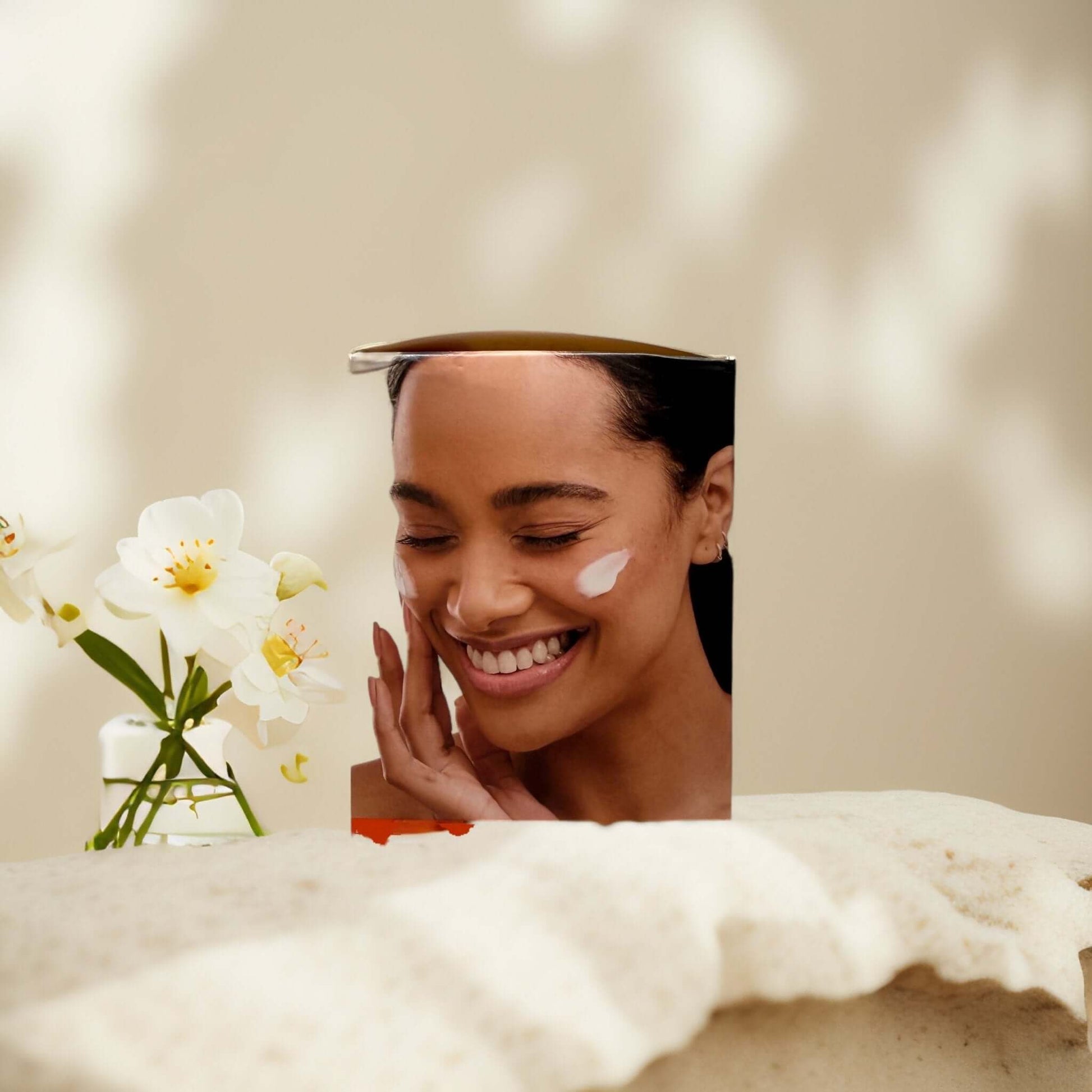Smiling woman applying Vitamin C Brightening Gel-Cream on her face.