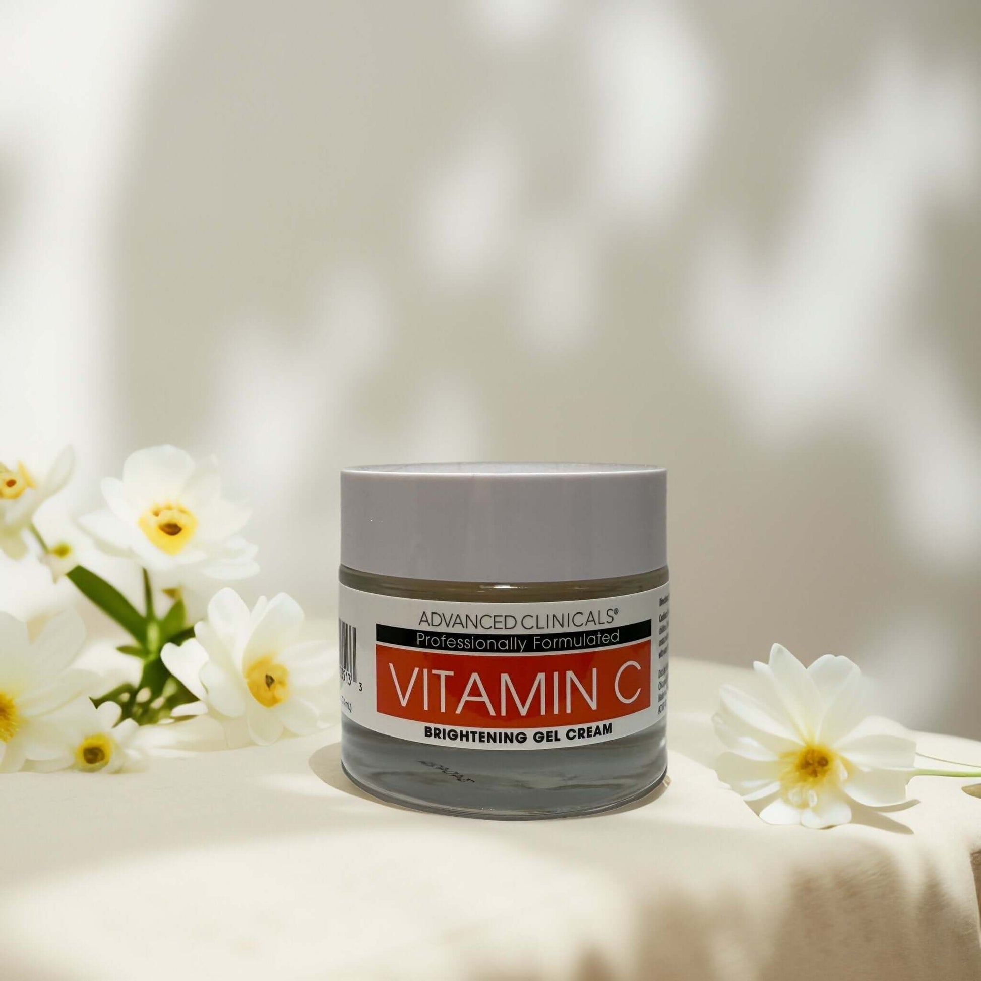 Vitamin C Brightening Gel-Cream by Advanced Clinicals 2oz on a floral background.